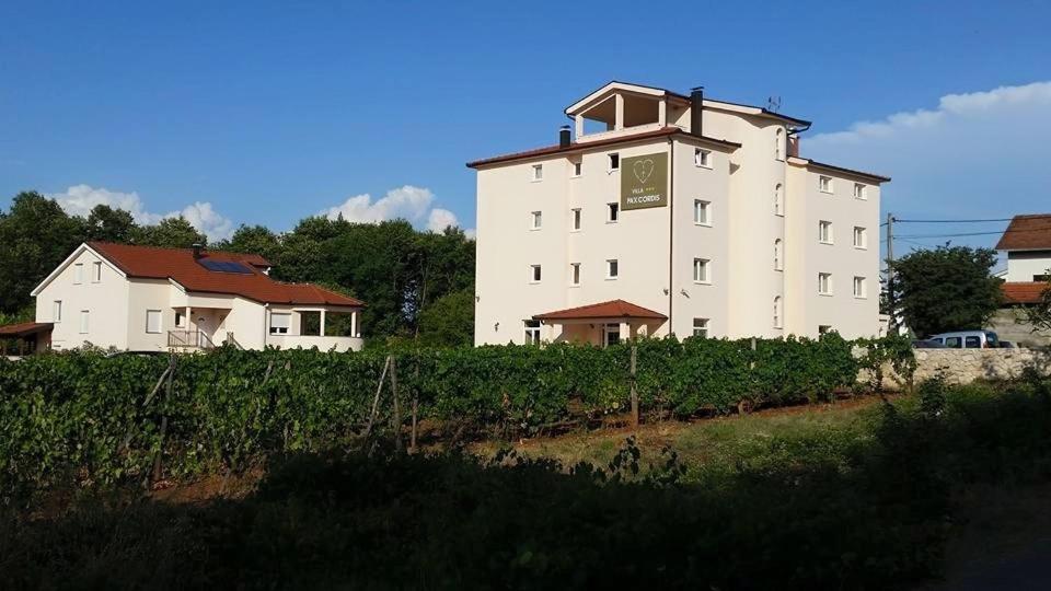 a large white building with a clock on it at Hotel Pax Cordis in Međugorje