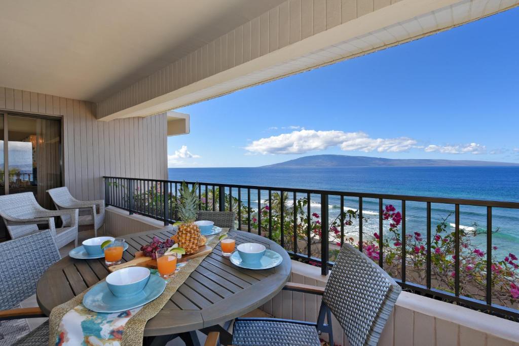 a balcony with a table and chairs and the ocean at Kaanapali Alii 385 in Kaanapali