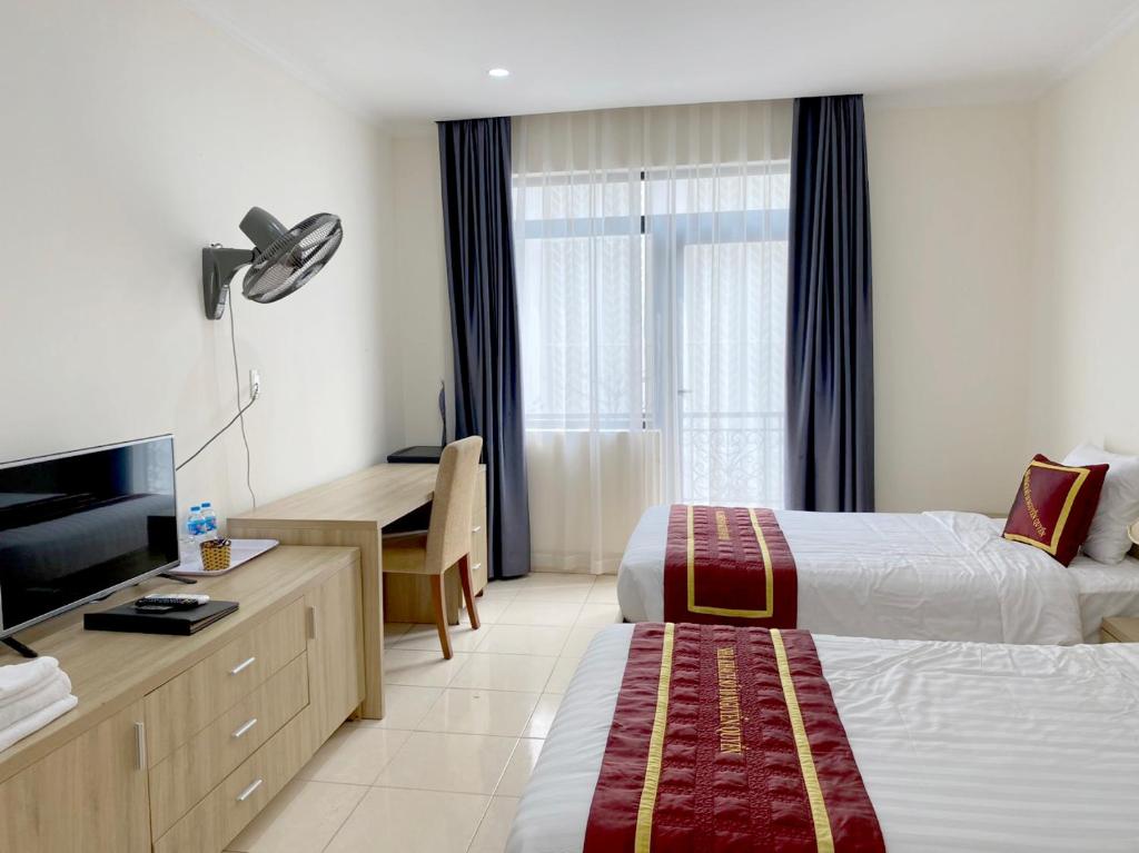 Postel nebo postele na pokoji v ubytování Nguyễn Quyền Hotel