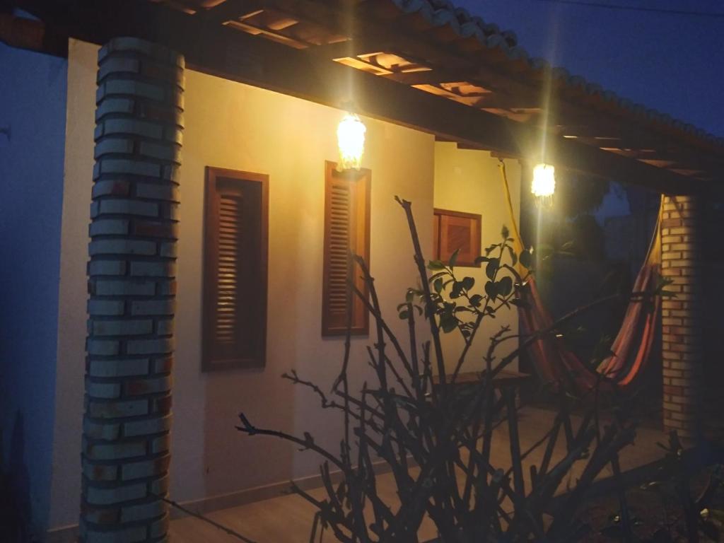 a house at night with a plant and lights at Yanne chalé 1 in Barra Grande