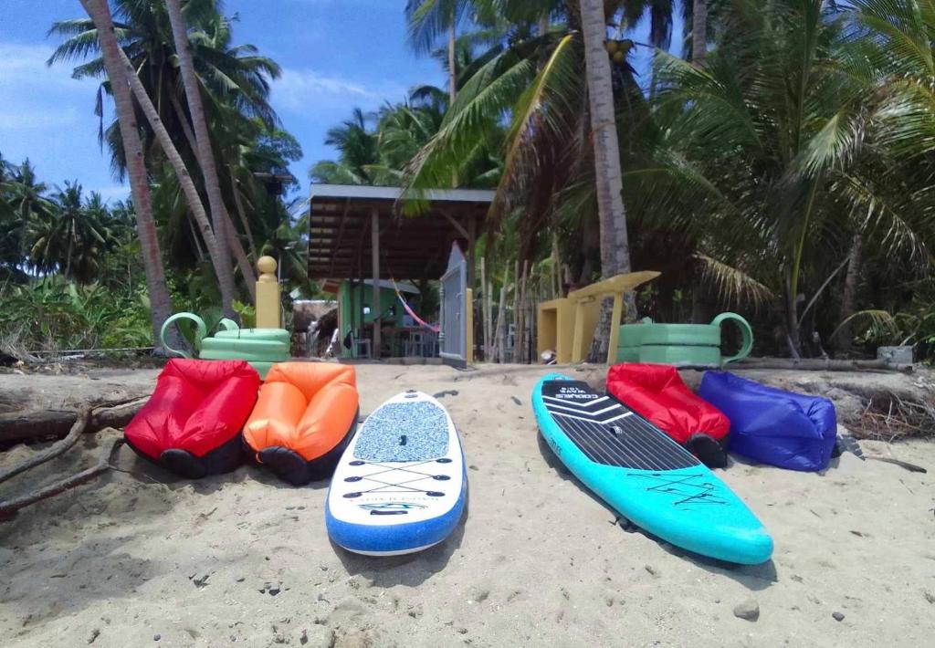 a group of surfboards sitting on the beach at Destiny Rainbow Beach Resort in Siquijor