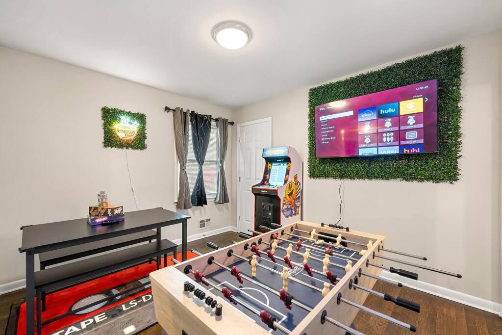 a living room with a game table and a video game at Big Red House in ATL by Hartsfield-Jackson Airport in Atlanta