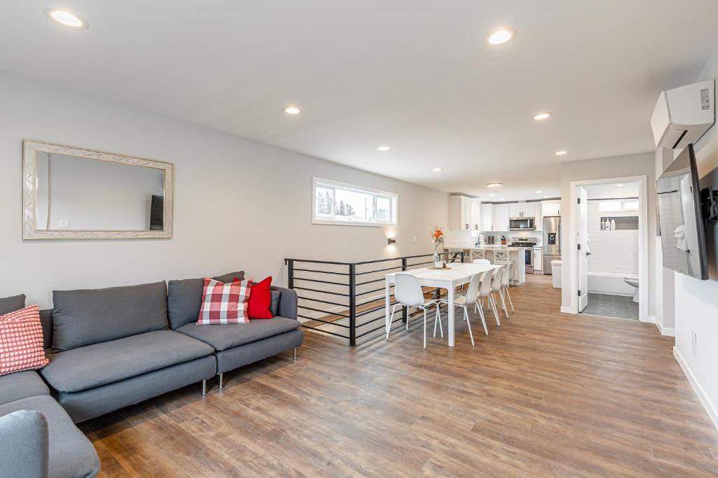 a living room with a couch and a table at Beautifully remodeled Rambler in South Seattle in Seattle