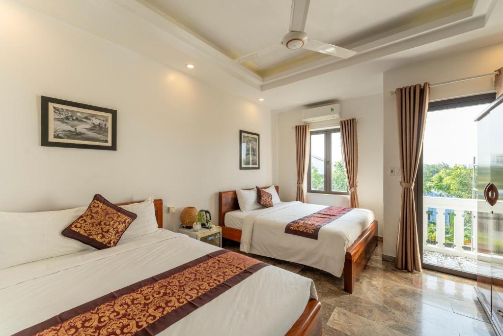 Postel nebo postele na pokoji v ubytování Rice River Villa - Hoi An
