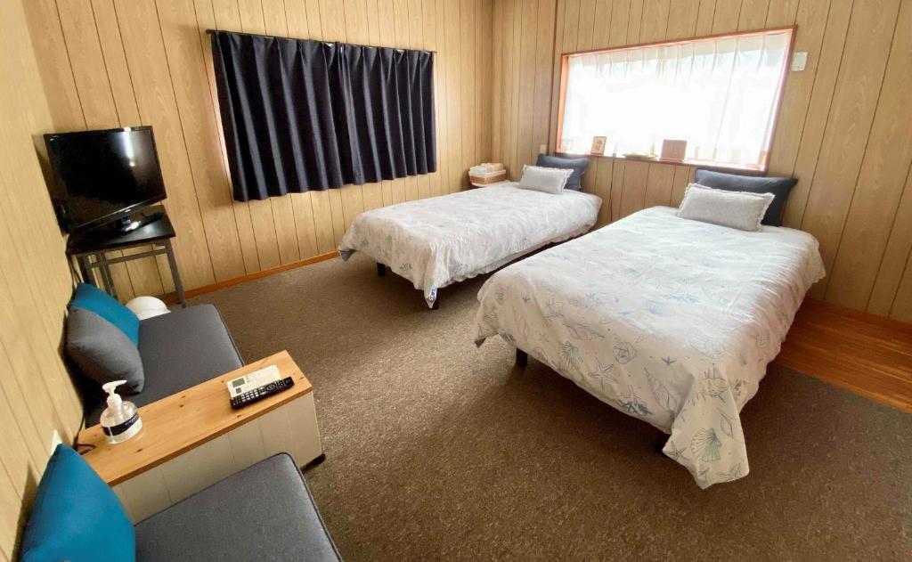 Postel nebo postele na pokoji v ubytování ホライゾン