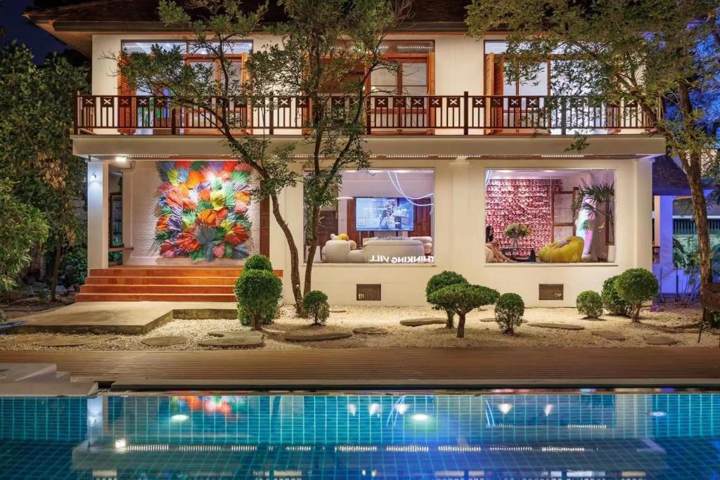 a house with a swimming pool in front of it at 曼谷2000平方米庄园别墅 超大泳池sukhmvit位置绝佳 9间卧室 in Amphoe Phra Khanong