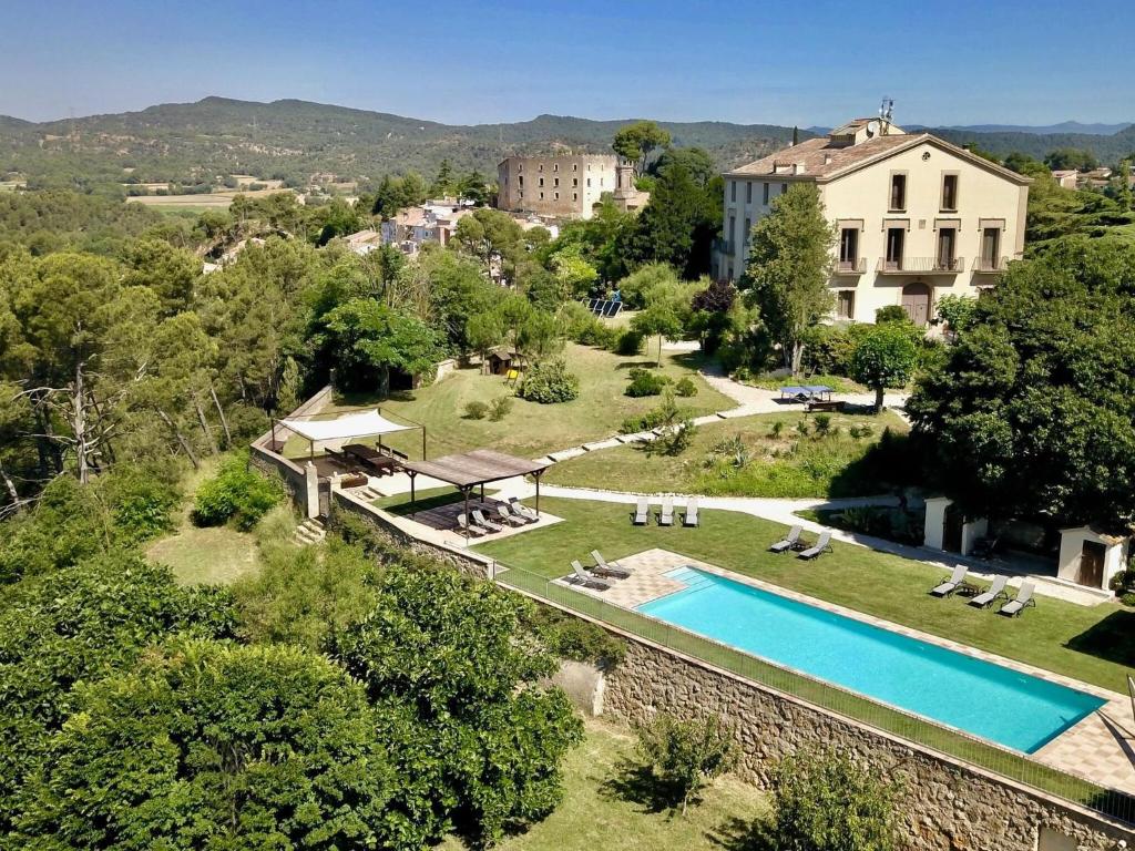 an aerial view of a villa with a swimming pool at Flat Riu d'Agost with garden terrace in La Torre de Claramunt