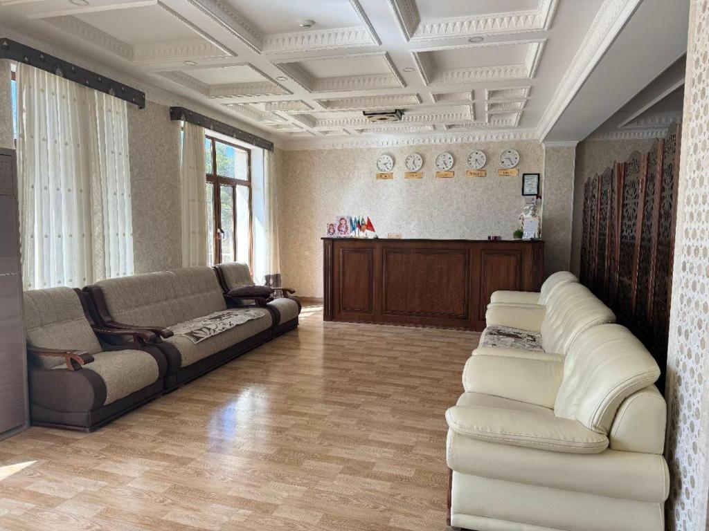 a living room with two couches and a couch at Al-Khabib in Bukhara