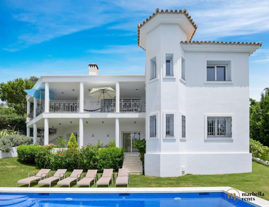uma casa branca com uma piscina em frente em Amazing Villa in Marbella! em Marbella