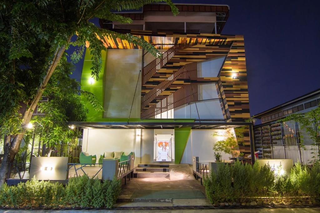 a house with a staircase on the side of it at Delio Boutique Hotel in Udon Thani
