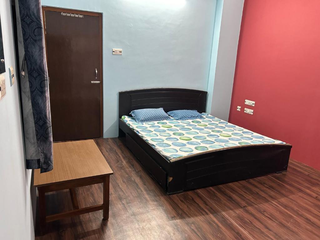a small bedroom with a bed and a table at SANGAM PALACE in Bettiah