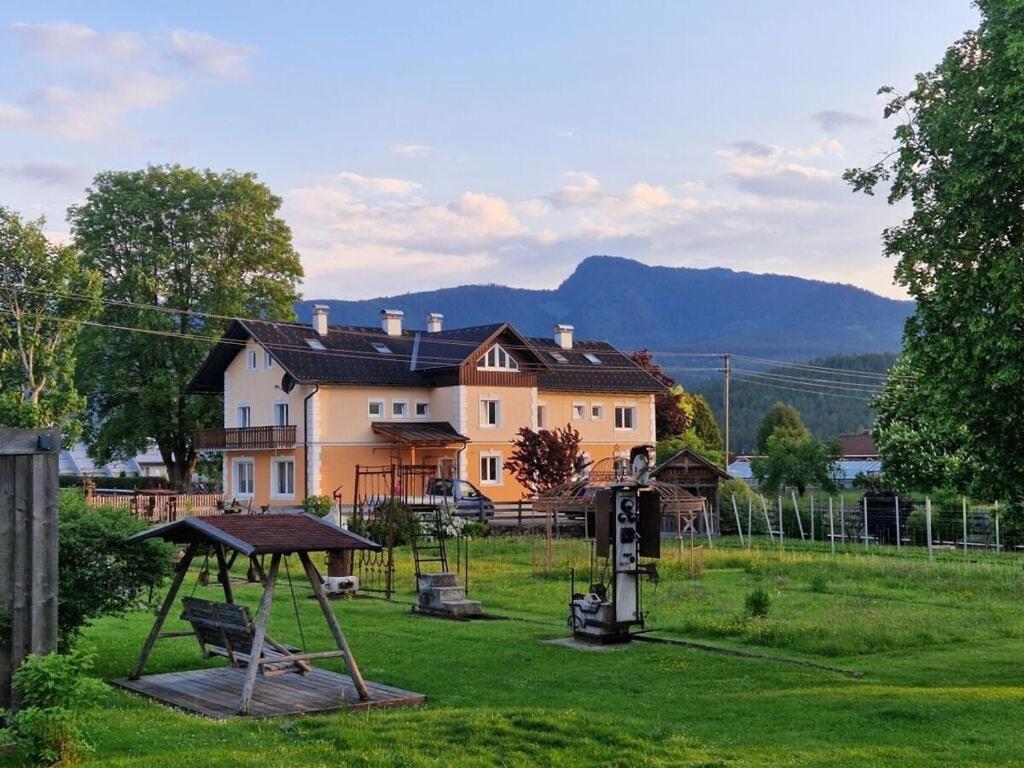 a yard with a playground in front of a house at Daffodil Modern Retreat in Bad Mitterndorf