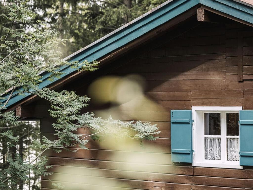 a window on the side of a wooden house at Mountain hut Hochpillberg Tyrol in Pill