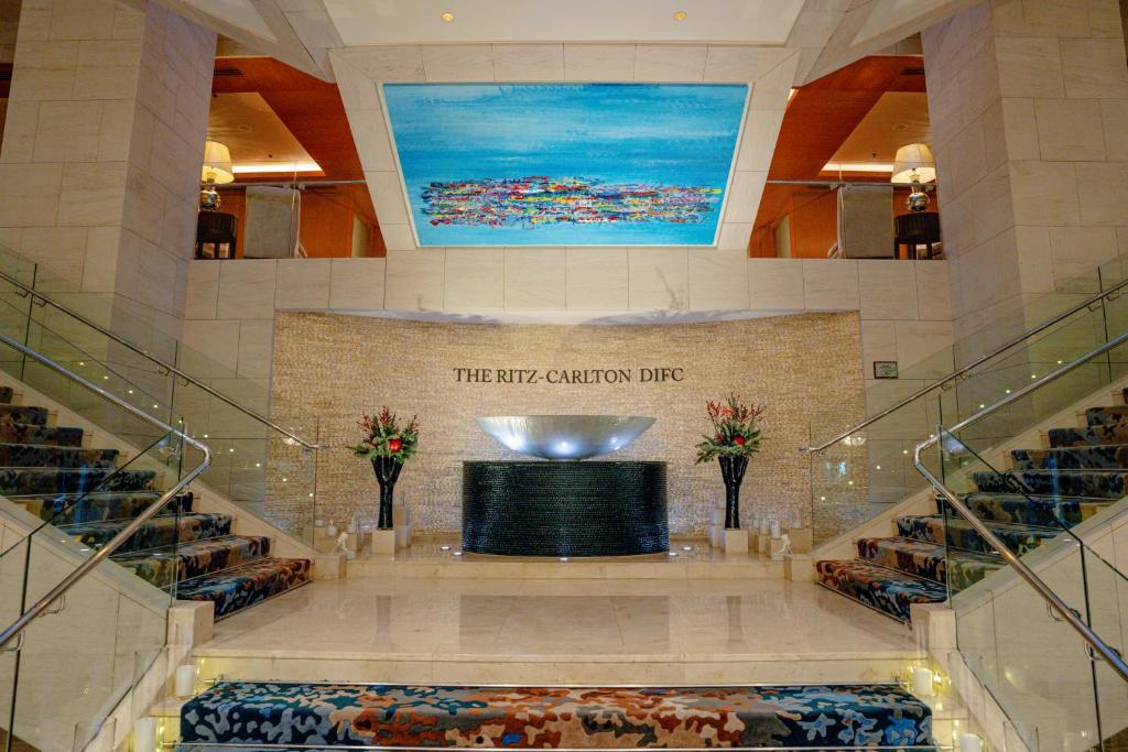a large lobby with a stage in a building at Ritz Carlton DIFC Downtown Dubai in Dubai