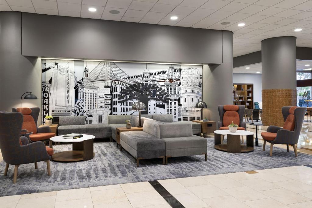 a lobby with a couch and chairs in a building at Oakland Marriott City Center in Oakland