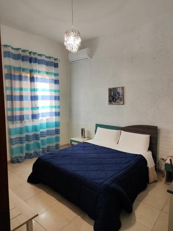 Postel nebo postele na pokoji v ubytování B&B AMURI RANNI