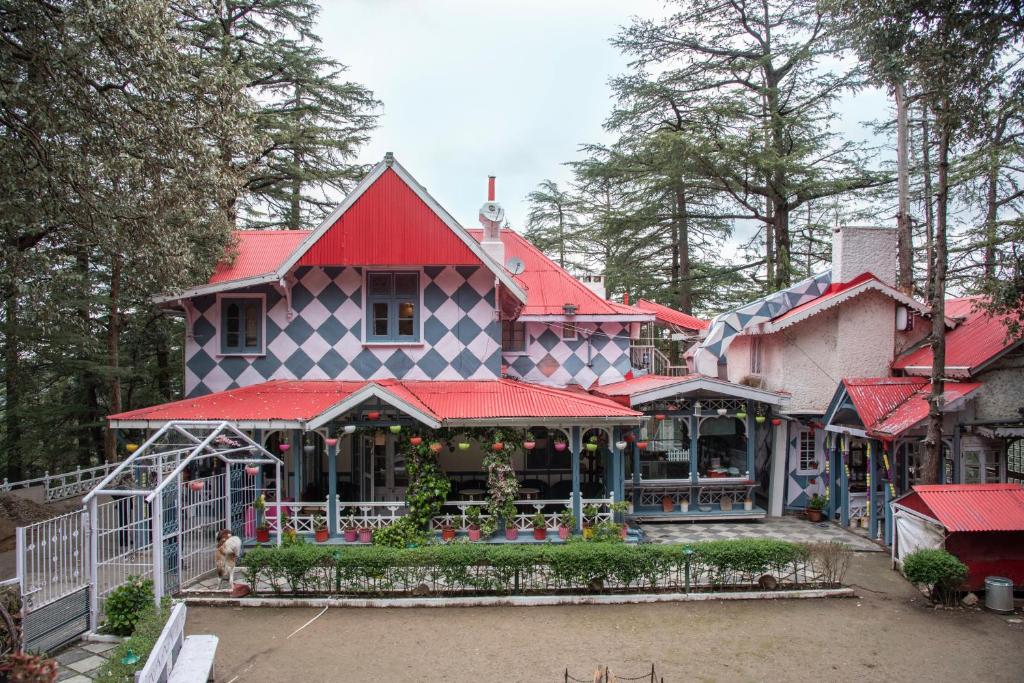 a large house with a red roof at Heritage Villas - Shimla British Resort, Near Mall in Shimla