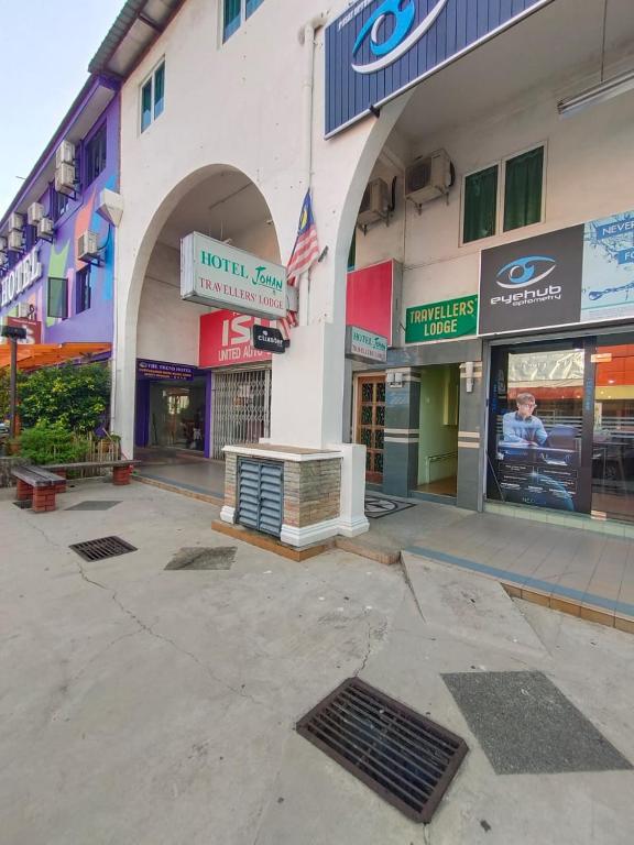 a store front of a building with signs on it at TRAVELLERS LODGE in Malacca