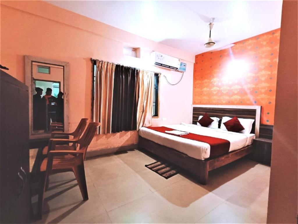a bedroom with a bed and a desk and a chair at Hotel Krishna Residency Puri Excellent Stay in Puri