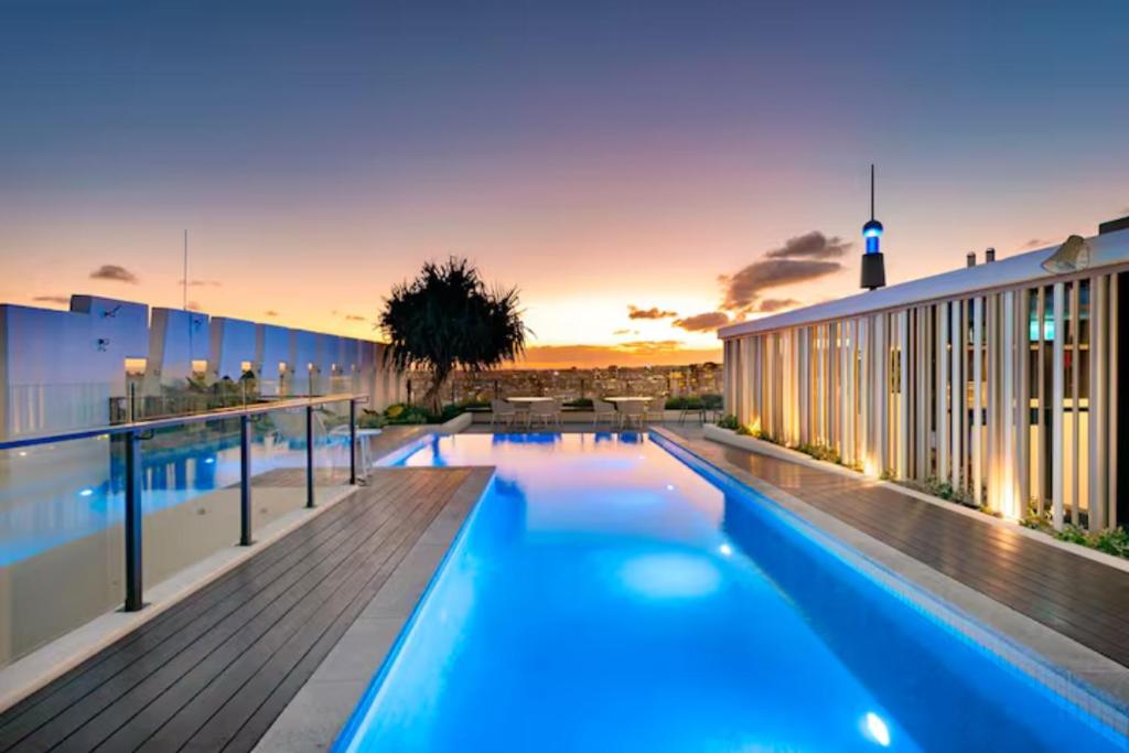 a swimming pool on the roof of a building at Urban Elegance 2B2B w parking, pool South Brisbane in Brisbane