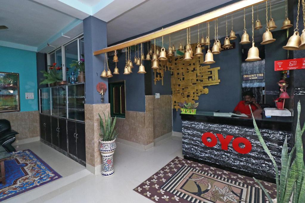 un restaurant avec un bar éclairé au mur dans l'établissement OYO Flagship Fun Friday Guesthouse, à Bodh Gaya