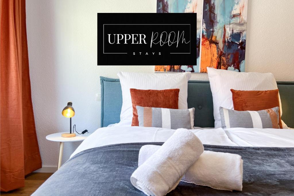 a bedroom with two beds and a sign that reads upper room warp at UPPER ROOM Apartment im Zentrum mit kostenfreiem Parkplatz in Neustadt an der Weinstraße
