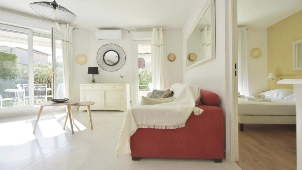 a bedroom with a bed and a red chair at LE 5 CROISETTE OR in Cannes