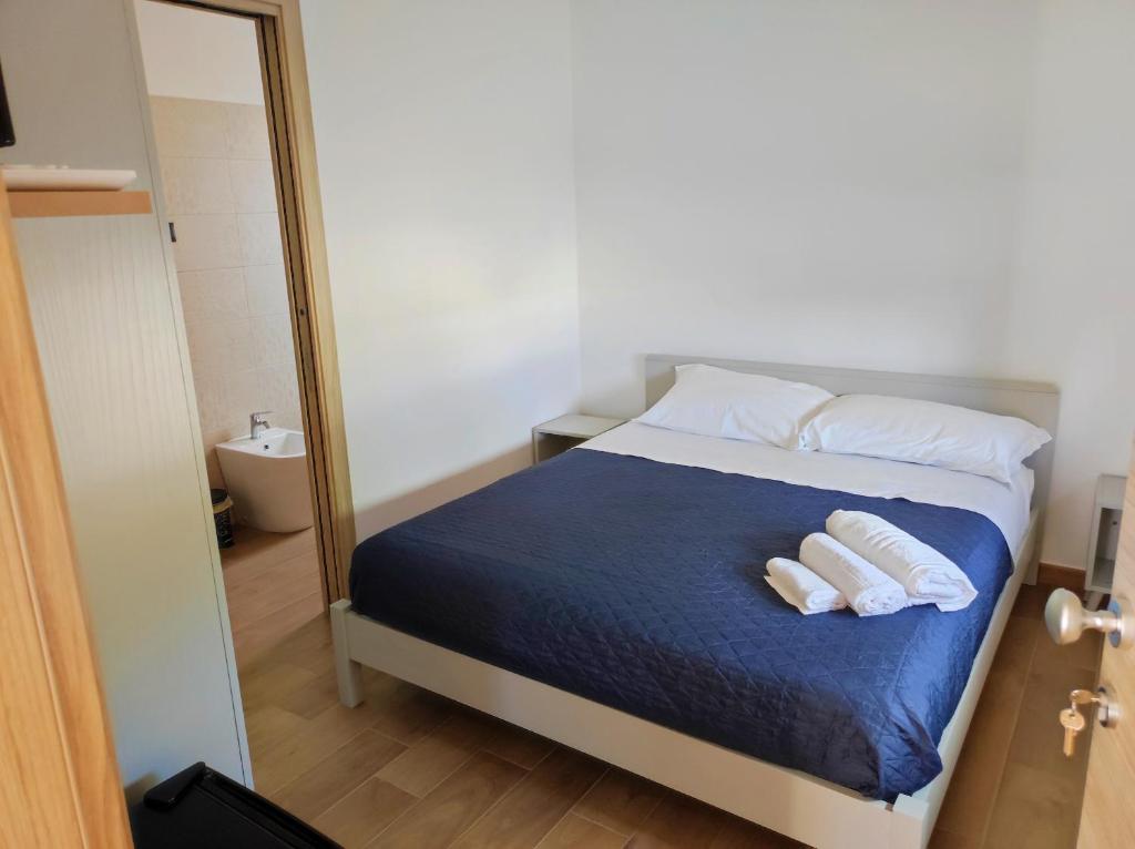 a bedroom with a bed with two pillows and a mirror at Civico 185 in Acri