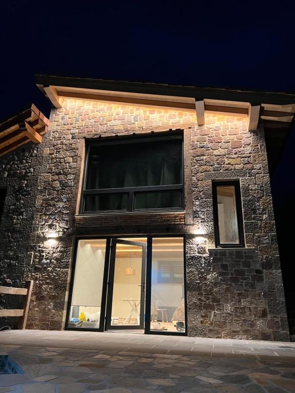 a brick building with windows at night at El Gallinero de Tiago in Lebena