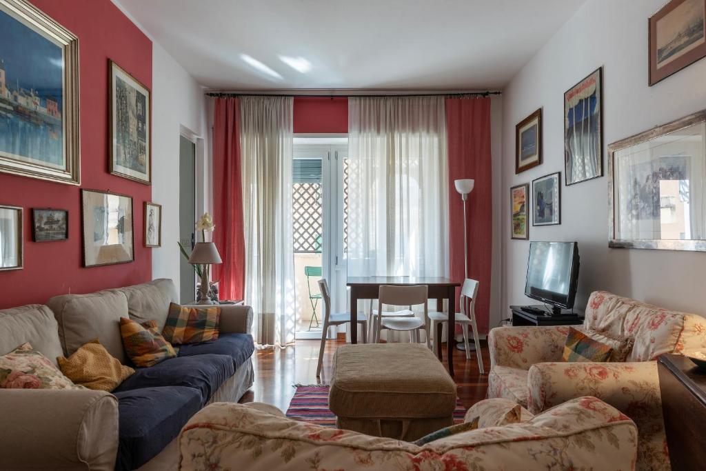 a living room with a couch and a table at Cipro Apartment with balconies in Rome