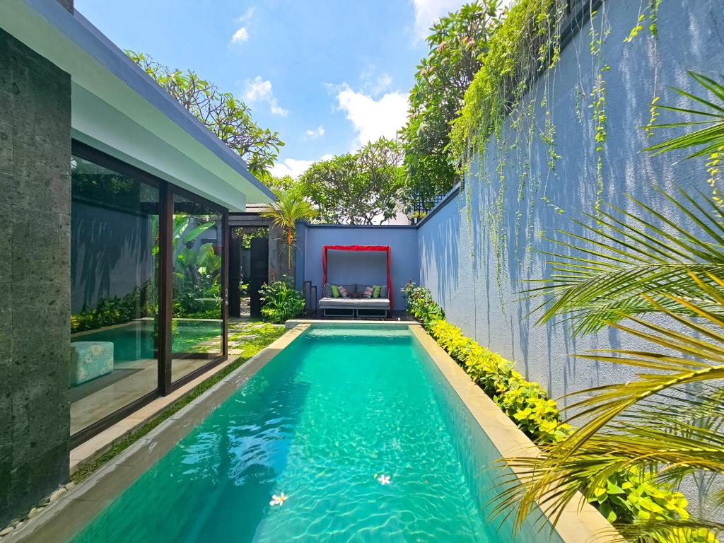 an infinity pool in the backyard of a house at Seminyak Icon - by Karaniya Experience - CHSE certified in Seminyak