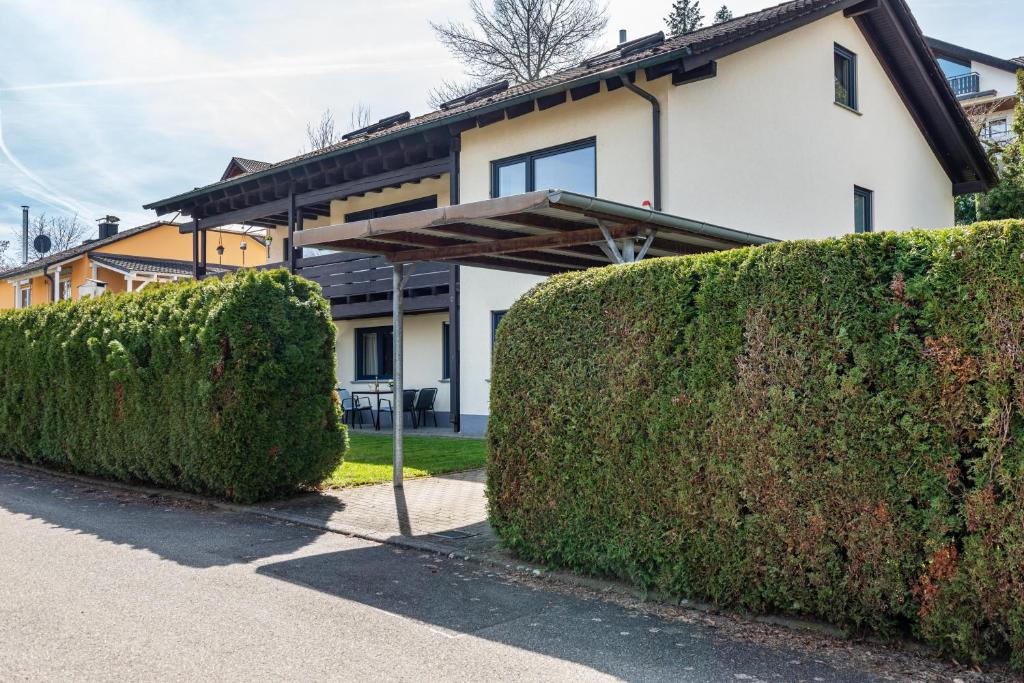 a house with two hedges in front of it at Ferienwohnung Reichle in Stockach