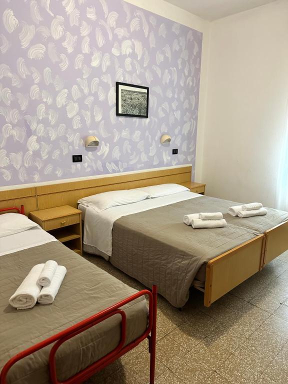 Postel nebo postele na pokoji v ubytování Hotel Enna Rimini