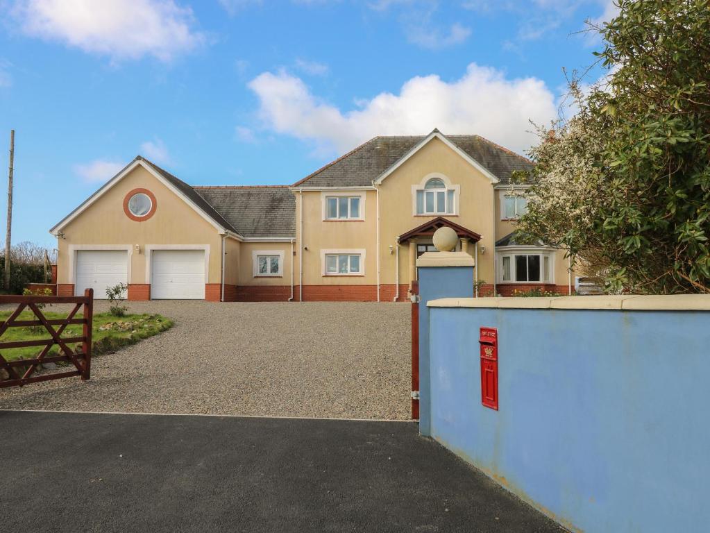 a large house with a driveway and a fence at The Annexe, Meadow Croft in Haverfordwest