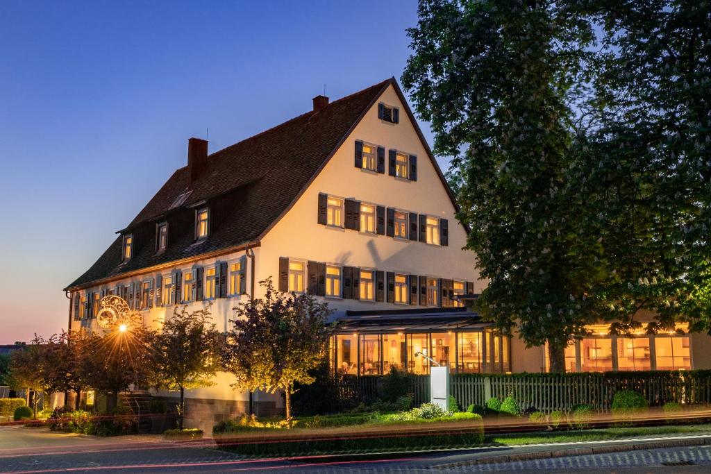 a large white building with a black roof at Rebers Pflug in Schwäbisch Hall