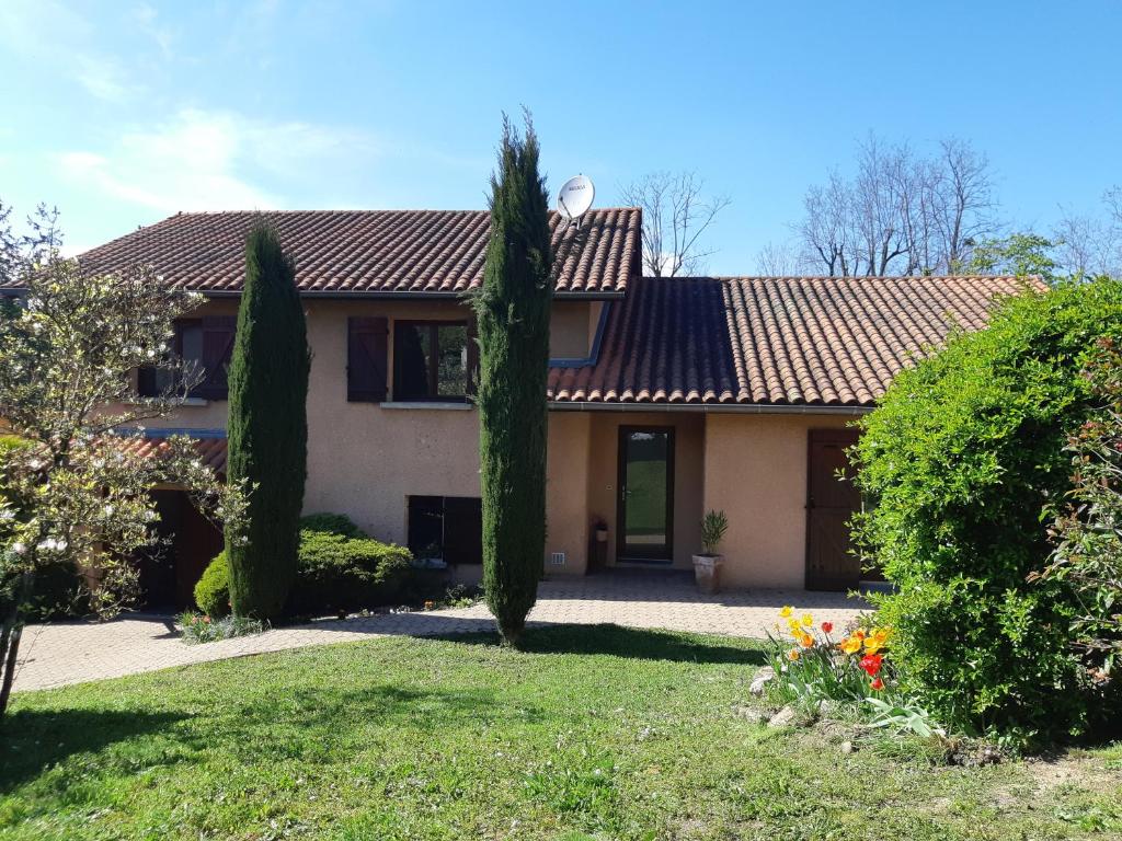 a house with a tiled roof and two trees at KERJEANNE in Cailloux-sur-Fontaines