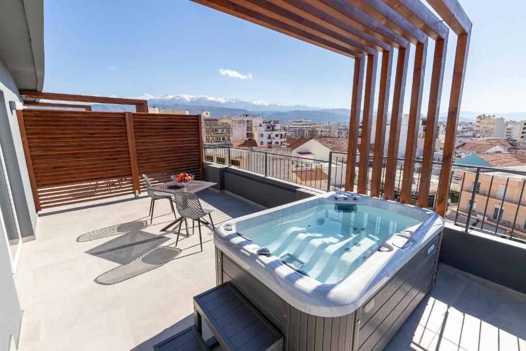 a hot tub on the balcony of a building at Anele Luxury Suites in Chania Town