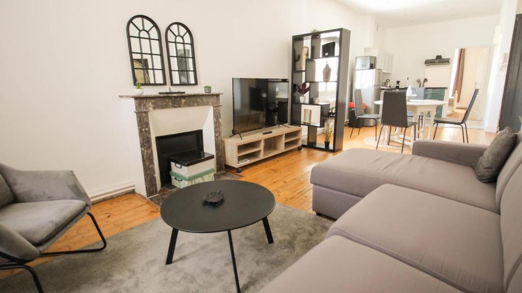 a living room with a couch and a fireplace at Residence Pasteur Angouleme in Angoulême
