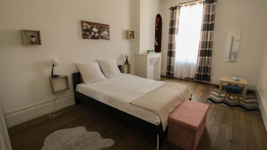 a small bedroom with a bed and a window at Residence Pasteur Angouleme in Angoulême