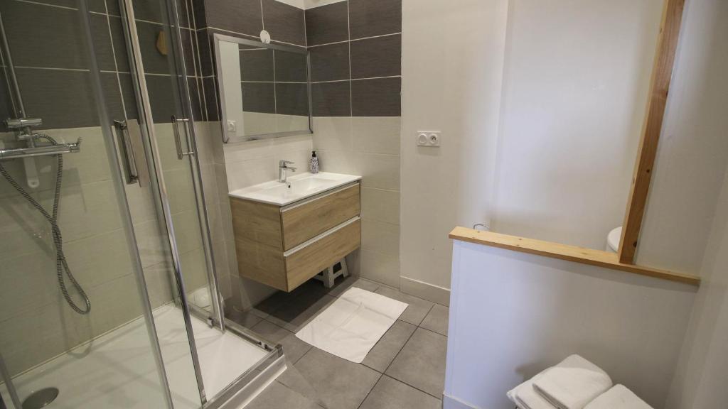 a bathroom with a sink and a shower at Residence Pasteur Angouleme in Angoulême