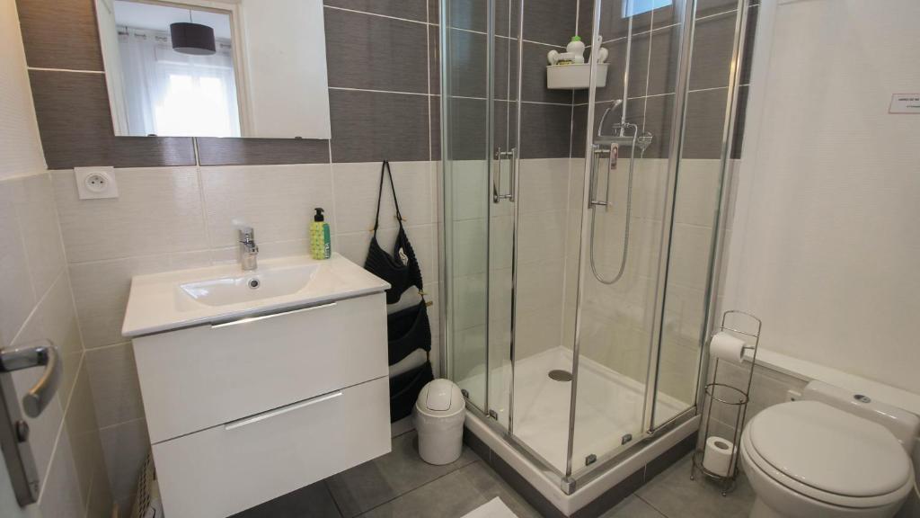 a bathroom with a shower and a sink and a toilet at Residence Pasteur Angouleme in Angoulême