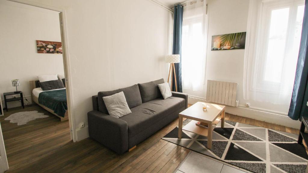 a living room with a couch and a bed at Residence Pasteur Angouleme in Angoulême