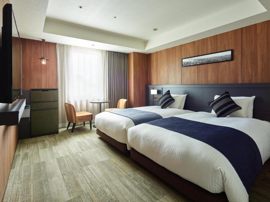 a hotel room with a large bed and a desk at Mitsui Garden Hotel Otemachi - Tokyo in Tokyo