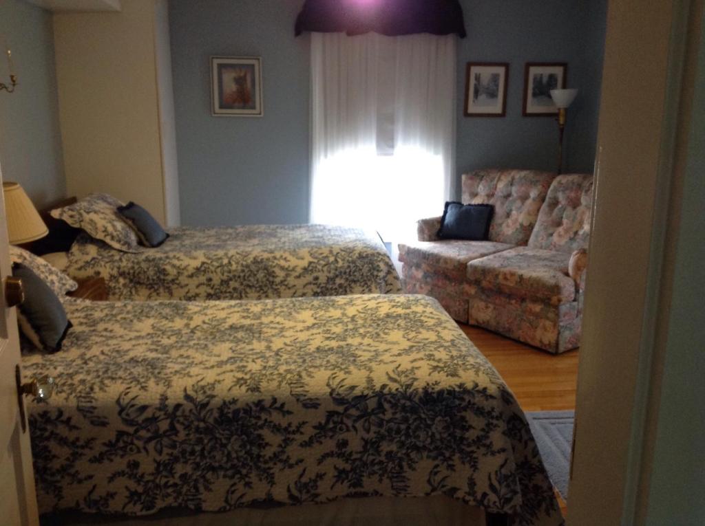 A bed or beds in a room at Maple Tourist Home B&B