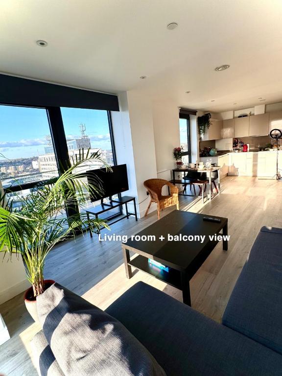 a living room with a view of a city at Wembley stadium apartment in London