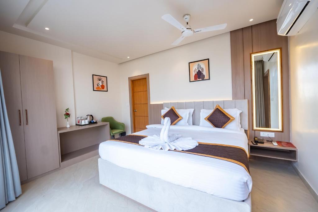 a bedroom with a large white bed in a room at DEV RESIDENCY ( A UNIT OF THE ELEGANCE ) in Varanasi