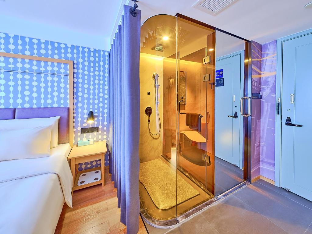 a bedroom with a shower with a glass door at CityNote Hotel - Beijing Road Peasant Movement Institute Station in Guangzhou