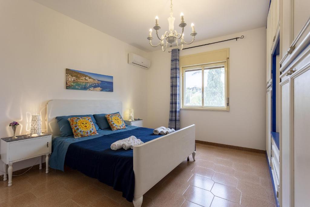 a bedroom with a bed and a chandelier at Mare e relax in Menfi