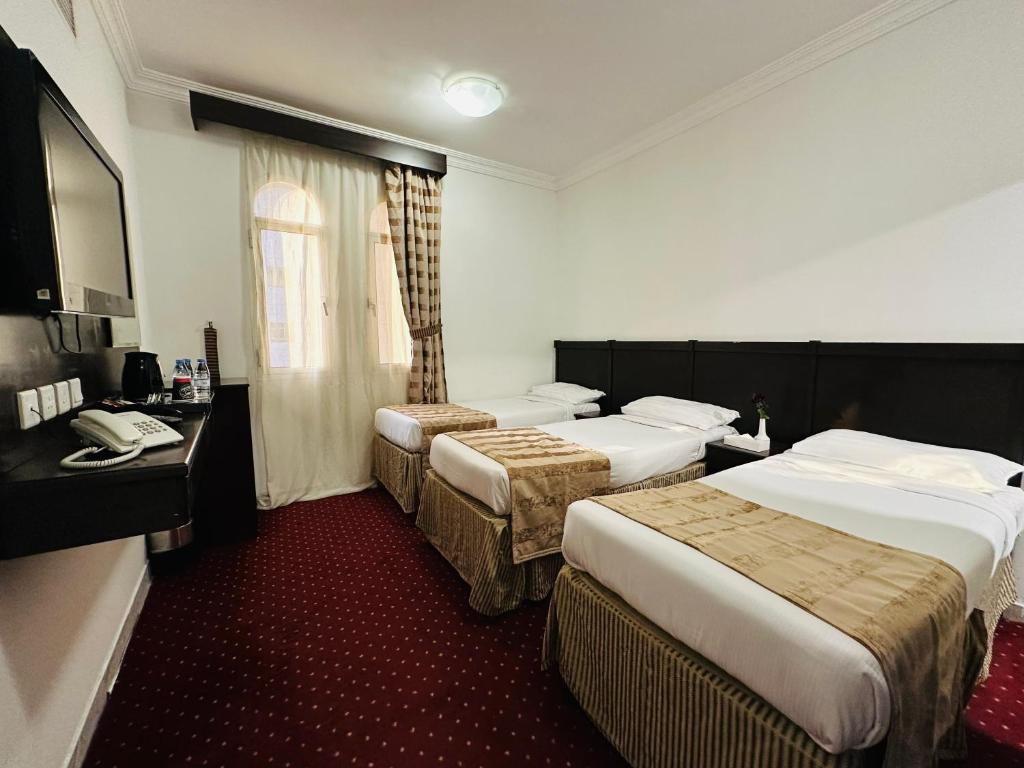 Postel nebo postele na pokoji v ubytování Miaad Al Majd Hotel