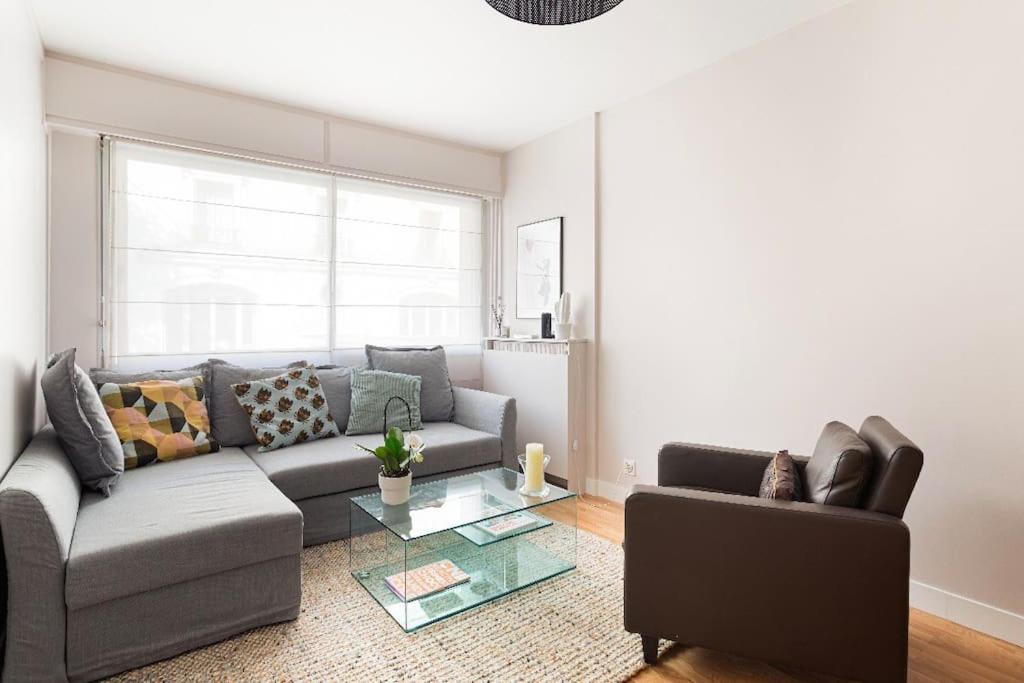 a living room with a couch and a table at Appartement 75006 paris ! in Paris
